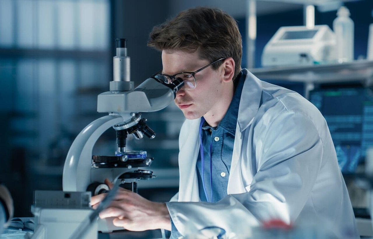 Researcher working at a microscope